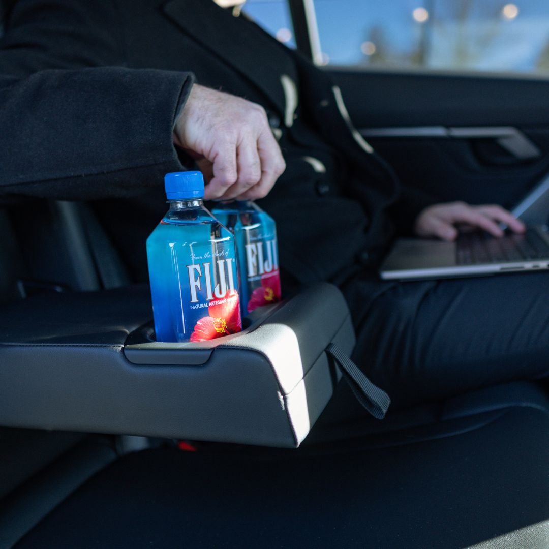 URVIP executive car interior with FIJI water and laptop workspace Boston corporate travel